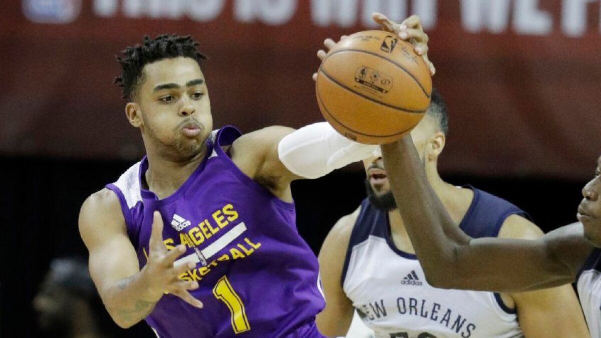 Lakers guard D'Angelo Russell battles with Chieck Diallo of the Timberwolves for a loose ball during a game on July 8.