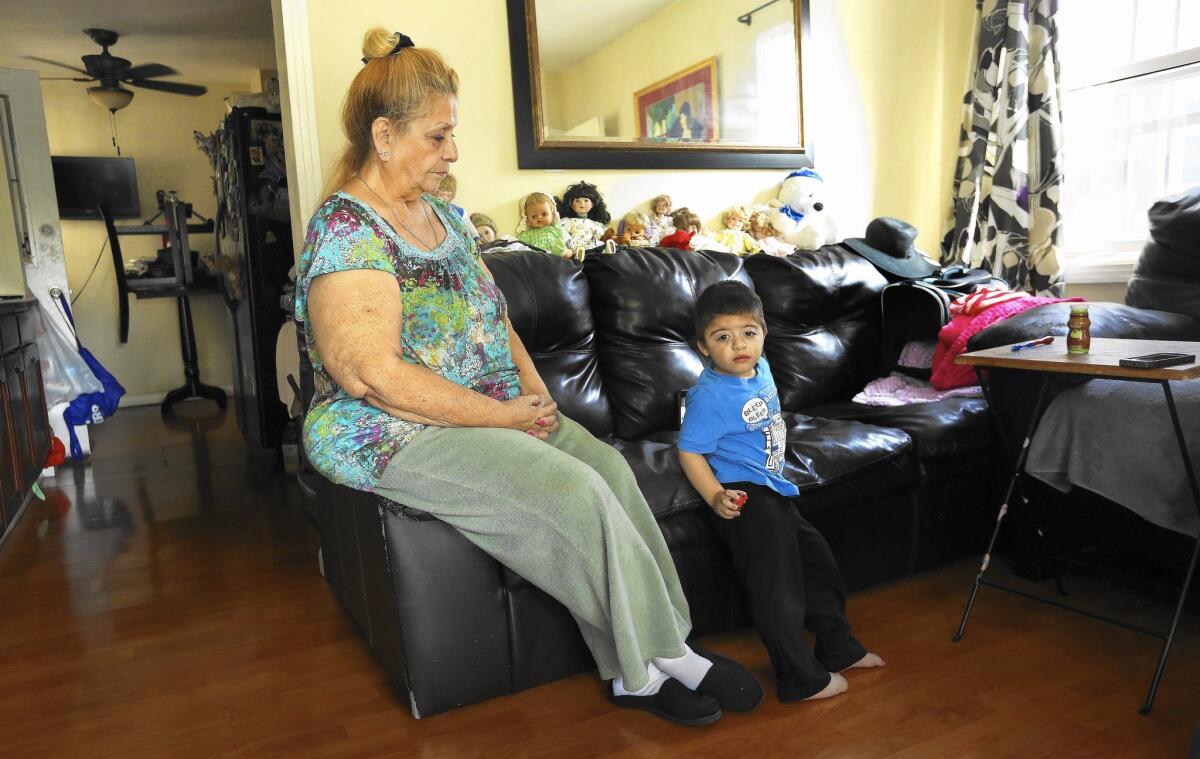 Grace Potvin and her grandson Shaun, 2, at home in Commerce. The Potvin home was found to have lead levels requiring cleanup.