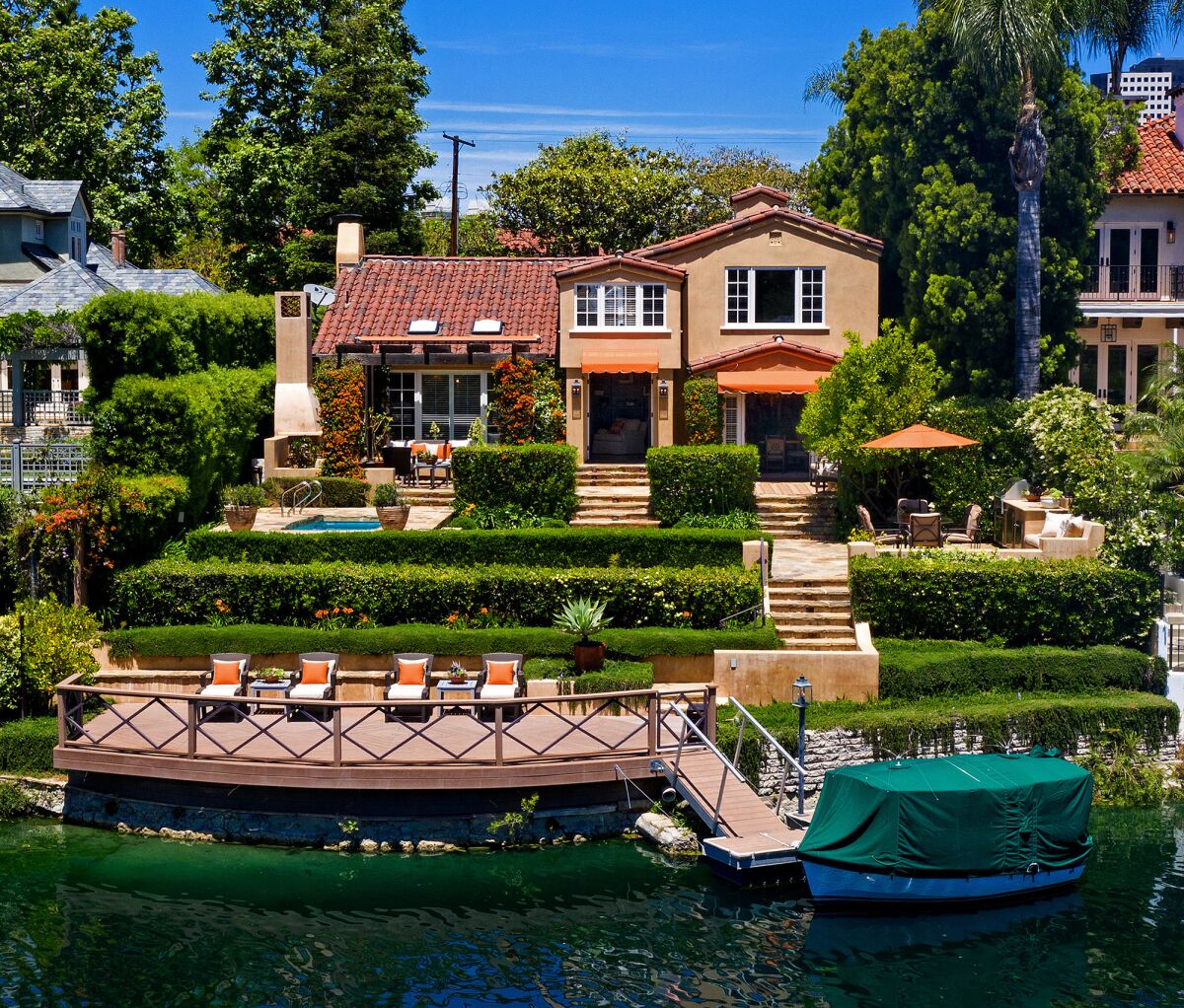 Exterior of Spanish-style home with boat dock