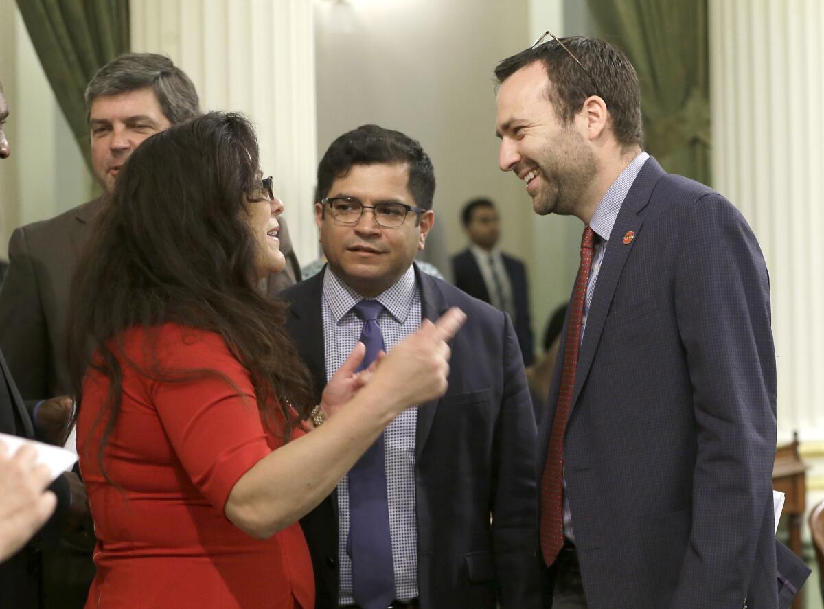 Assemblyman Jimmy Gomez (D-Echo Park), center, is proposing an expansion to California's paid family-leave law.