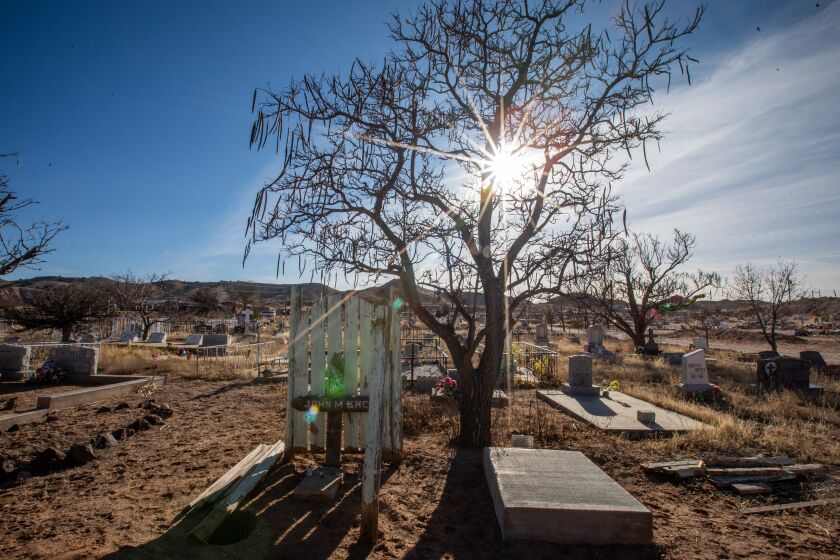 Espanola, NM - March 08: Morning in Sacred Heart Cemetery on Wednesday, March 8, 2023, in Espanola, NM. In a one-year period ending in June 2022, Rio Arriba County reported an estimated 50 fatal overdoses, giving it the highest rate in New Mexico. It was nearly four times the national rate of about 33 per 100,000. (Francine Orr / Los Angeles Times)