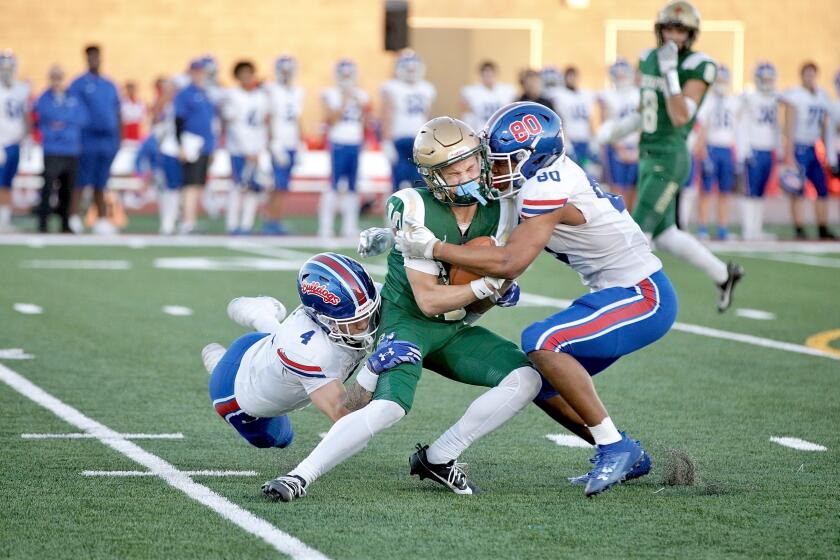 St. Bonaventure punt returner Jack Cunningham is tackled by Folsom's RJ Whitten and Brian Ray.