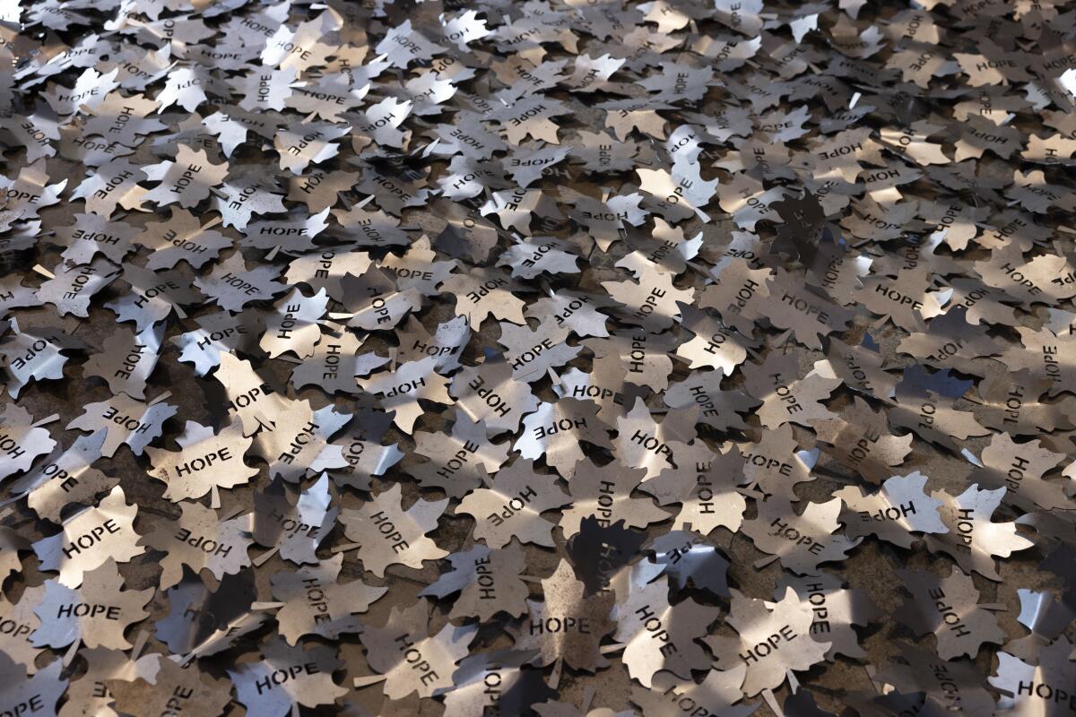 Steel leaves inscribed with the word "hope." 