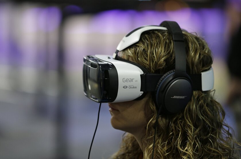 A woman tries out an Oculus virtual-reality headset at a Facebook event in San Francisco on March 26.