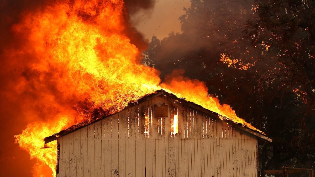 A home in Lake County burns as the Mendocino Complex fire rips through the area on July 31.