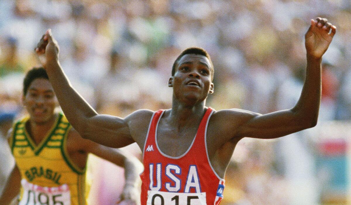 Carl Lewis of the U.S. raises his arms as he wins the 200-meters final during the 1984 Olympic Games at the Coliseum in Los Angeles.