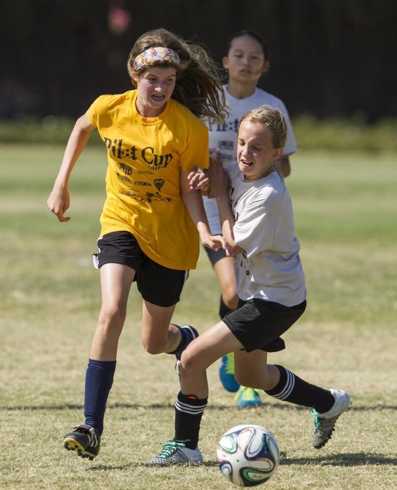Harbor Day's Isabel Gomez battles for a ball against Pegasus' Skylar Wilkison during a girls' 5-6 Gold Division game on Thursday.