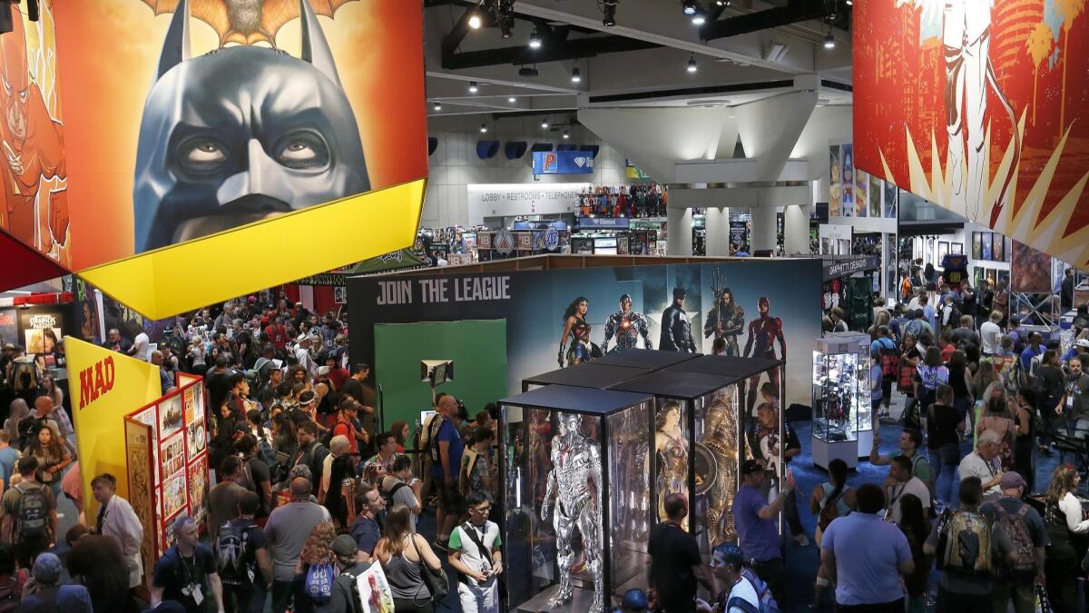 A crowd walks through the DC Comics booth at Comic-Con International 2017 at the San Diego Convention Center.