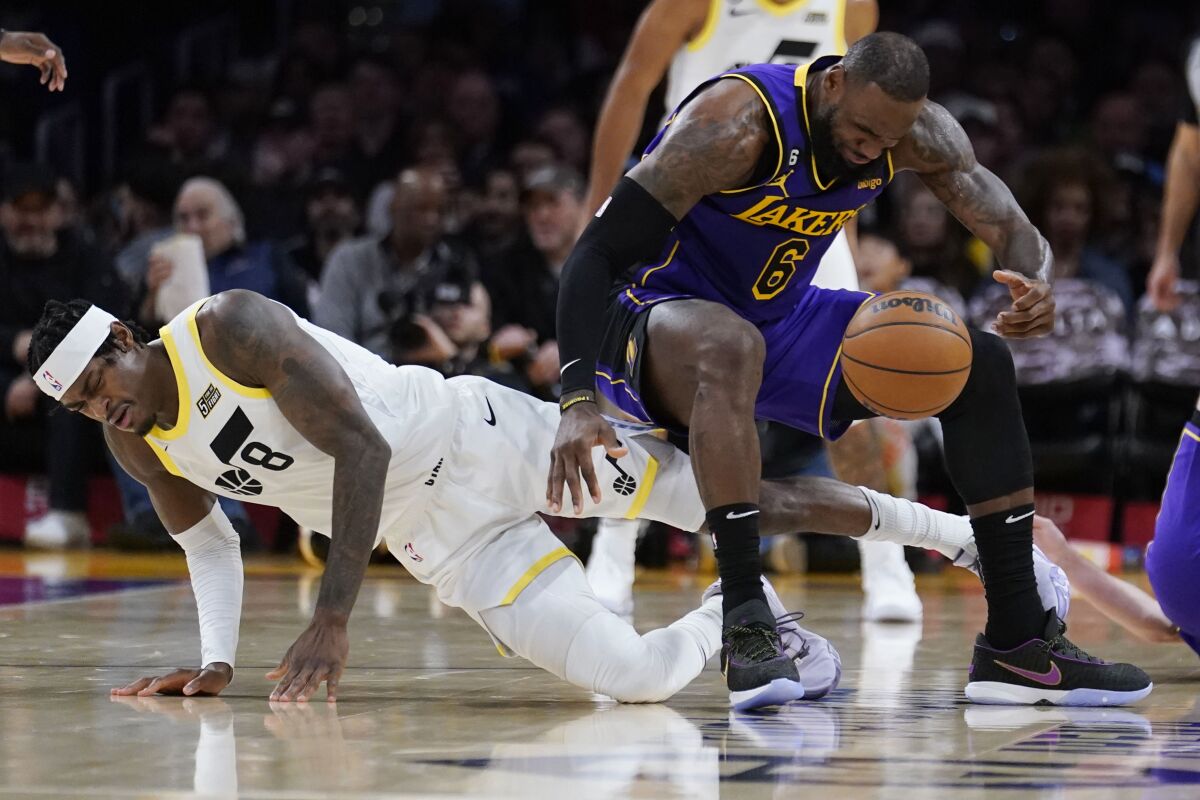 Lakers star LeBron James, right, collides with Utah Jazz forward Jarred Vanderbilt during the first half Friday.