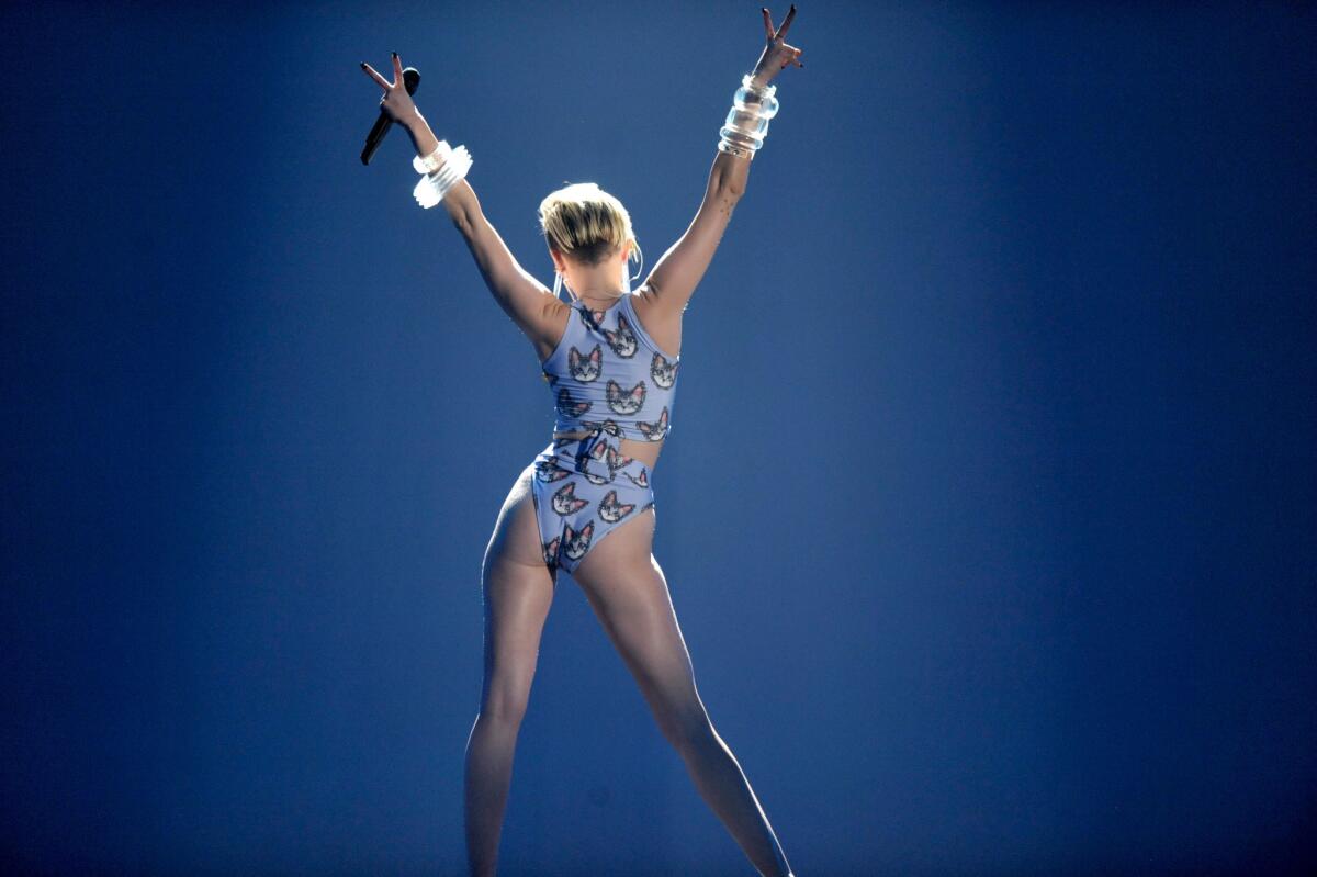 Miley Cyrus added to the media frenzy with her performance at the American Music Awards on Nov. 24, 2013, in Los Angeles.