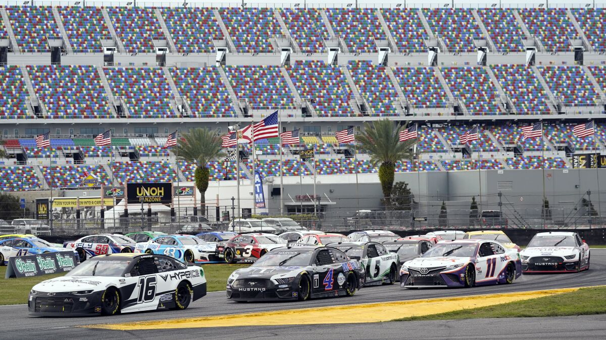 AJ Allmendinger (16) and Kevin Harvick (4) lead the field during the infield section of the Daytona road course.