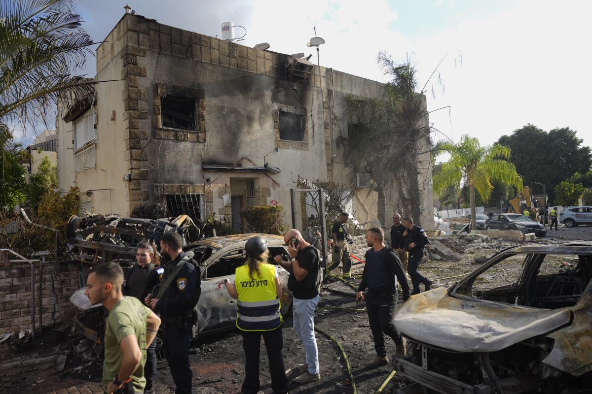 Israeli security forces examine the site hit by a rocket 