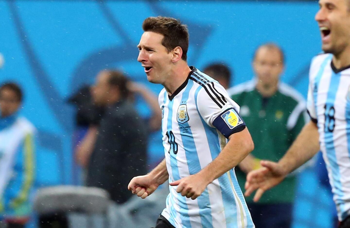 Argentina's Lionel Messi celebrates after his team wins the penalty shootout against the Netherlands to advance to the World Cup final.
