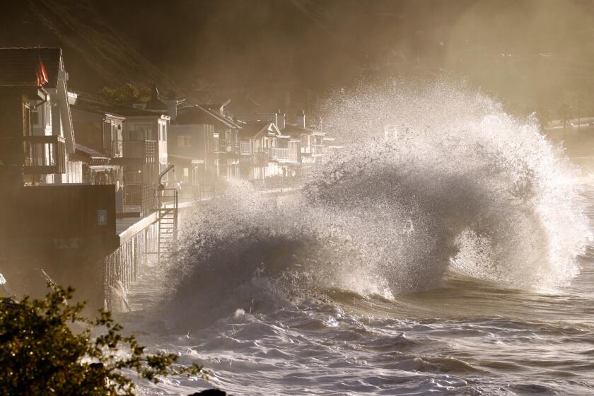 VENTURA, CA - JANUARY 07, 2016 - Forceful and beautiful waves crash into the sea walls of homes at Mondo's Beach under the mountains of the recent Solimar fire at high tide sunrise west of Ventura Thursday morning January 07, 2016 as El Nino storms move through Southern California with more rain and heavy surf. (Al Seib / Los Angeles Times)
