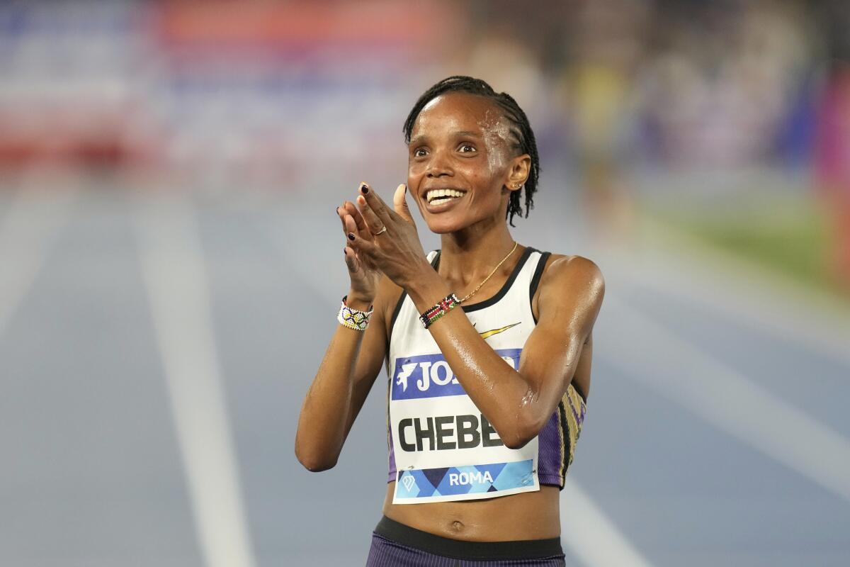Beatrice Chebet claps her hands after winning a 5,000-meter race.