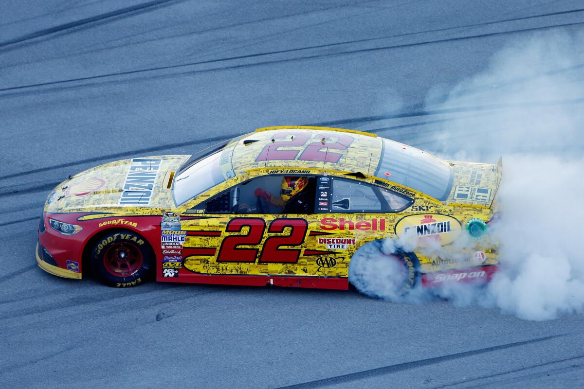 Joey Logano, driver of the No. 22 Shell Pennzoil Ford, celebrates with a burnout after winning the NASCAR Sprint Cup Series Hellmann's 500 at Talladega Superspeedway on Oct. 23.