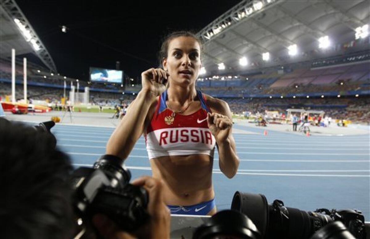 Russia's Yelena Isinbayeva receices advice from her coach in the Women's Pole Vault final at the World Athletics Championships in Daegu, South Korea, Tuesday, Aug. 30, 2011. (AP Photo/Kin Cheung)