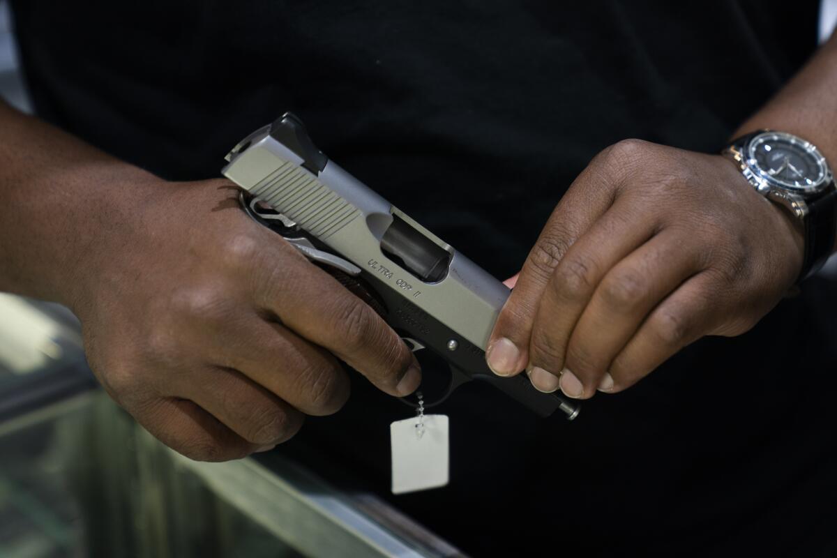 Closeup of a man's hands holding a handgun