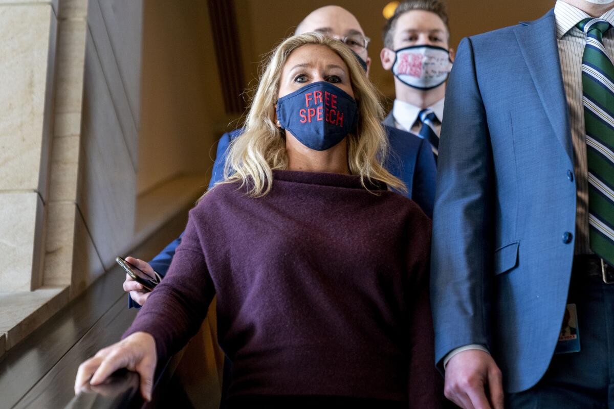 Rep. Marjorie Taylor Greene wears a "Free Speech" mask.