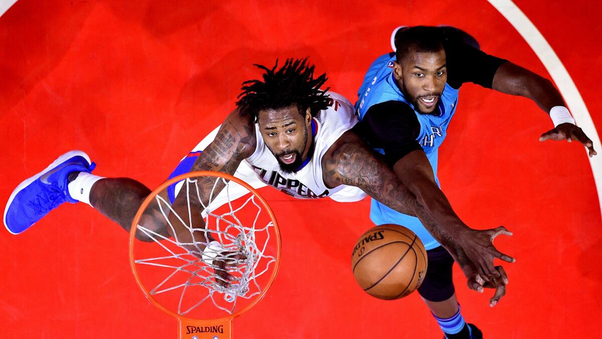 Clippers center DeAndre Jordan, left, and Hornets forward Michael Kidd-Gilchrist battle for a rebound during the first half of their game Sunday.