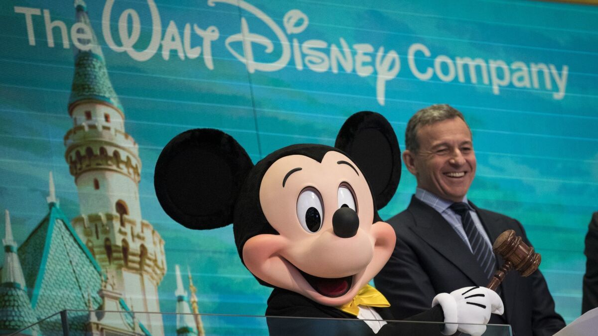 Mickey Mouse and Walt Disney Co. Chief Executive Bob Iger prepare to ring the opening bell at the New York Stock Exchange in November 2017.