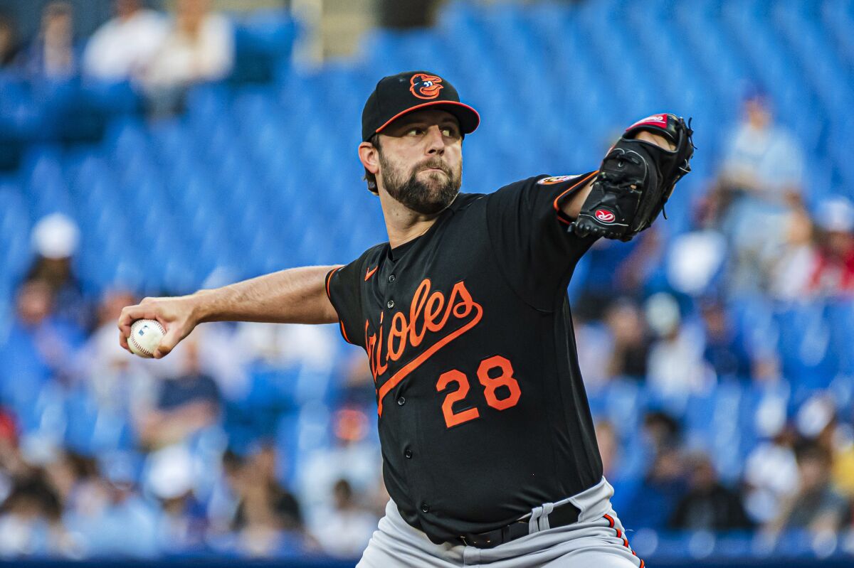 Baltimore Orioles starting pitcher Jordan Lyles throws to a Toronto Blue Jays batter during the first inning of a baseball game Tuesday, June 14, 2022, in Toronto. (Christopher Katsarov/The Canadian Press via AP)