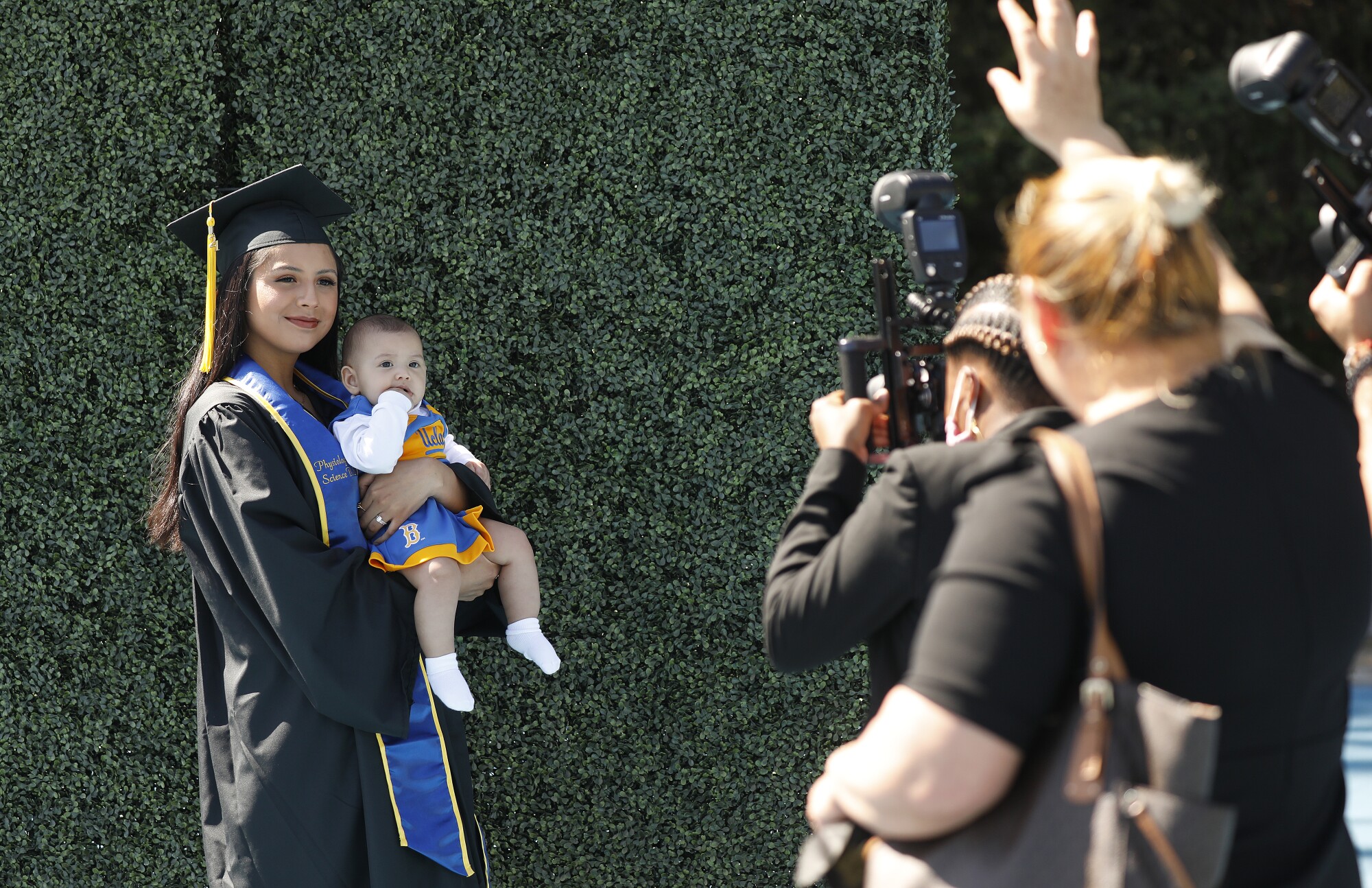 Kimberly Sanchez, 22, poses for photos holding her 6-month-old baby Alessandra Burnashkin