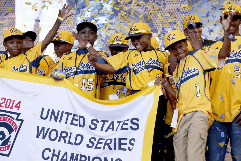 Jackie Robinson West Little League players attend a rally in celebration of their national title in Chicago on in August. Jackie Robinson West was stripped of its championship by Little League International on Wednesday.