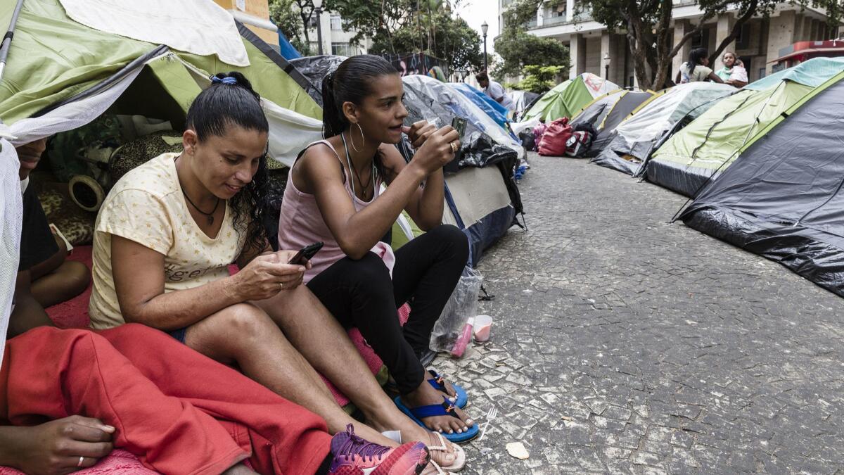 Women prepare to leave for work after their building, the Wilton Paes de Almeida, burned May 1.