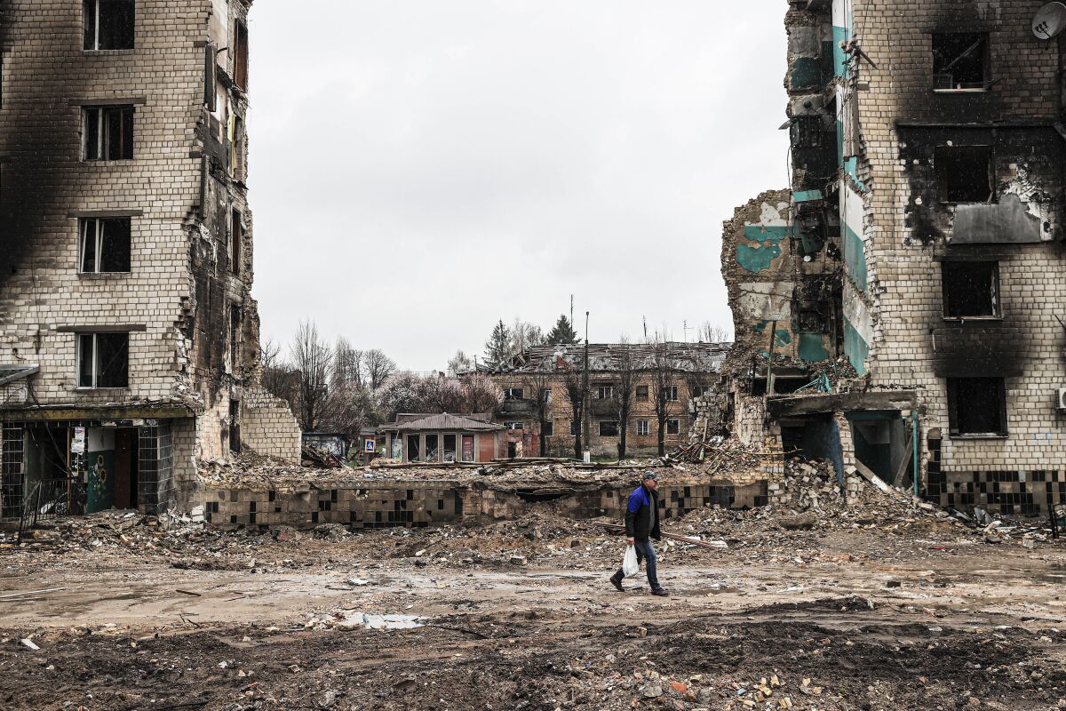 A Ukrainian walks through the ruins of damaged buildings in Borodyanka.