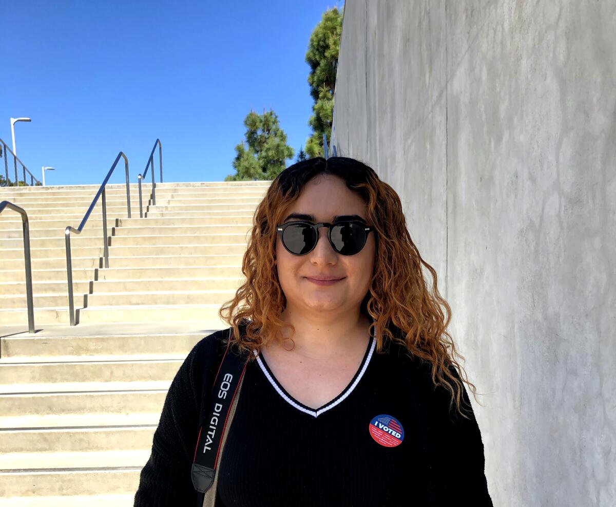 Mildred Dimas proudly wore her "I Voted" sticker after casting her ballot before class at East Los Angeles College on Tuesday. 