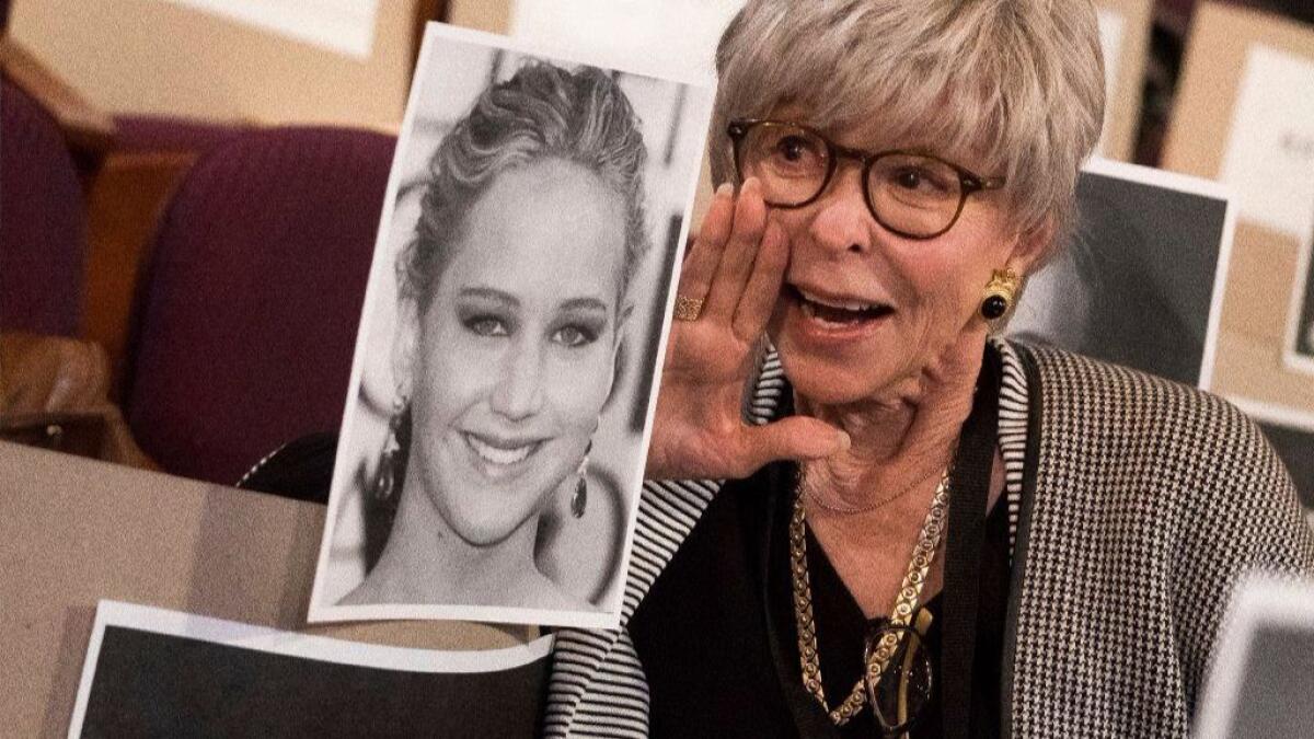 Rita Moreno poses next to Jennifer Lawrence's placeholder during rehearsals for the 90th Academy Awards in Los Angeles on Saturday, March 3, 2018. The Academy Awards will be held at the Dolby Theatre on Sunday, March 4.