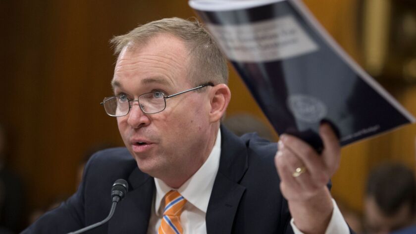 Defending the indefensible? Budget director Mick Mulvaney waves a copy of the president's budget proposal during Senate testimony this week.