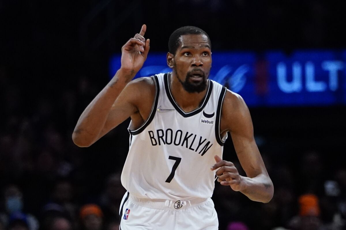 Brooklyn Nets' Kevin Durant (7) gestures after making a three-point shot during the second half of an NBA basketball game Wednesday, April 6, 2022, in New York. The Nets won 110-98. (AP Photo/Frank Franklin II)
