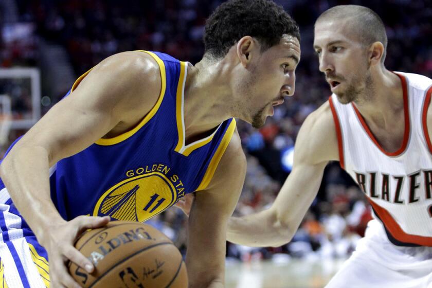 Warriors guard Klay Thompson drives the baseline against Trail Blazers guard Steve Blake in the first half Sunday.