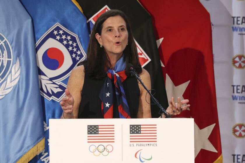 FILE - In this Aug. 1, 2017, file photo, U.S. Olympic Committee chief marketing officer Lisa Baird speaks about the Team USA WinterFest for the upcoming 2018 Pyeongchang Winter Olympic Games, at Yongsan Garrison, a U.S. military base in Seoul, South Korea. The longtime chief marketing officer of the U.S. Olympic Committee U.S. Olympic Committee is taking a similar position at New York Public Radio. Lisa Baird spent nine years with the USOC. She reimagined the organization's branding, cutting deals with United Airlines, Hershey, Nike, Polo and others. The value of the deals she brokered were estimated at $1 billion. (AP Photo/Lee Jin-man, File)