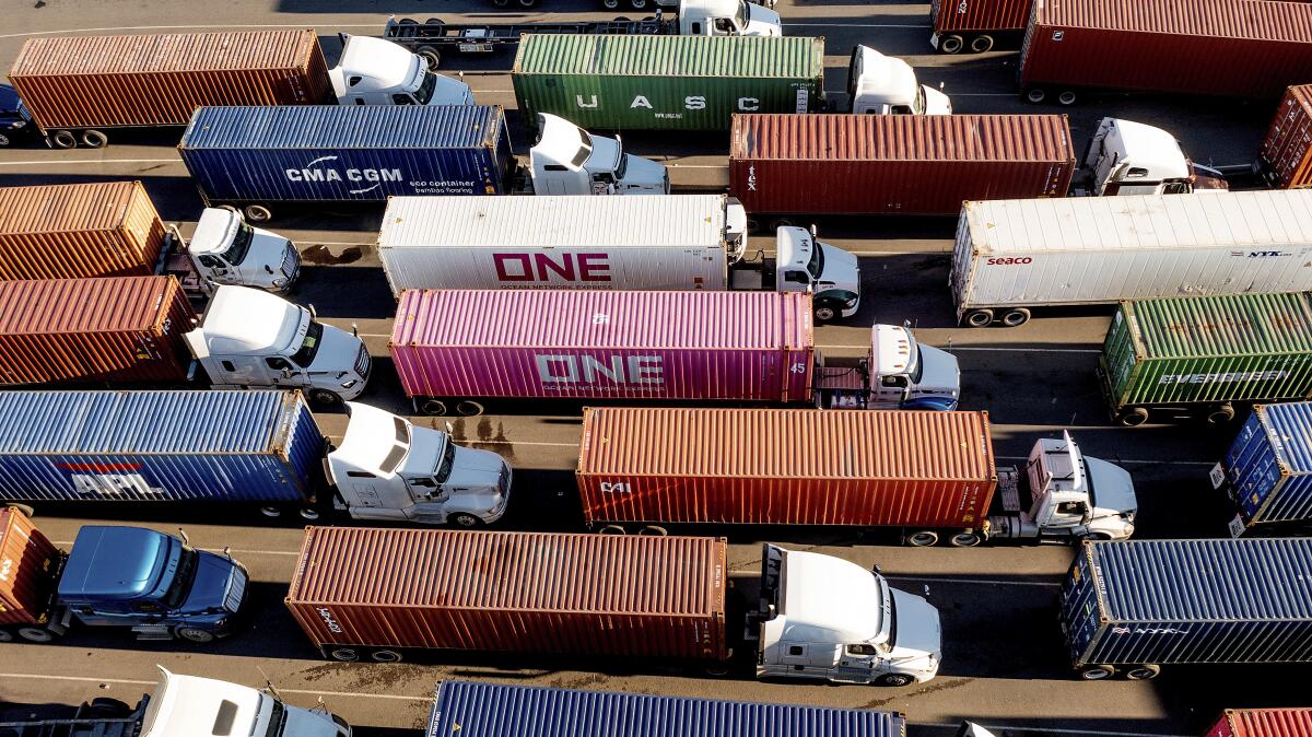 FILE - Trucks line up to enter a Port of Oakland shipping terminal on Nov. 10, 2021, in Oakland, 