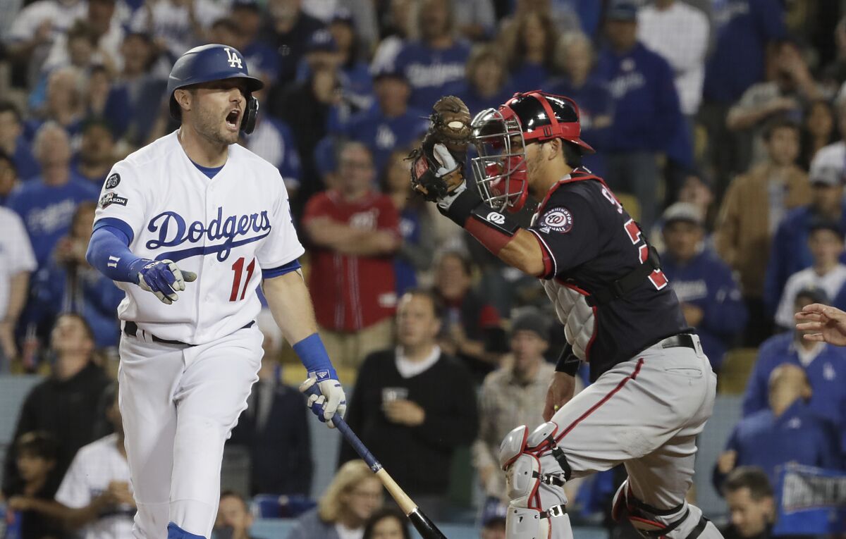 Dodgers center fielder A.J. Pollock reacts after striking out in the ninth inning.