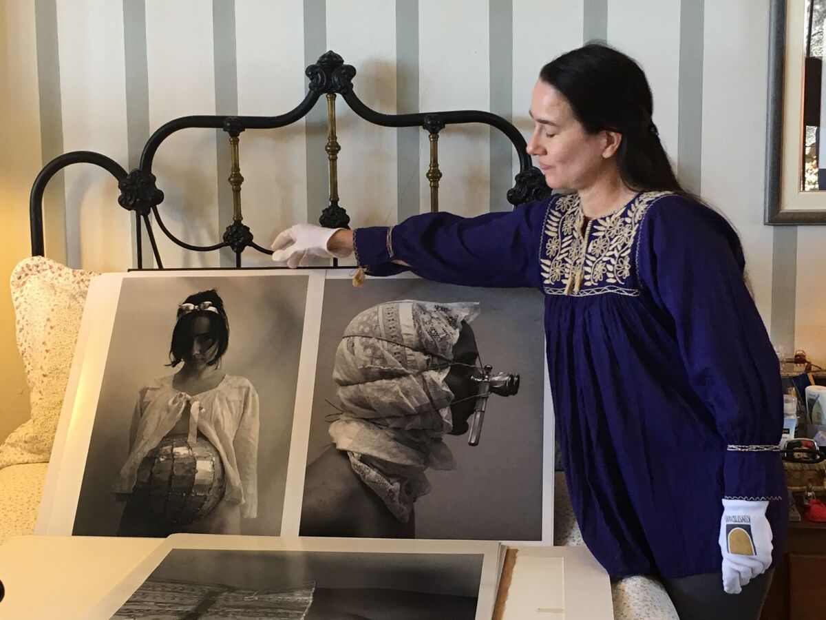 Artist Cirenaica Moreira displays her photographs at her home in Cojimar, Cuba. (Deborah Vankin/Los Angeles Times)