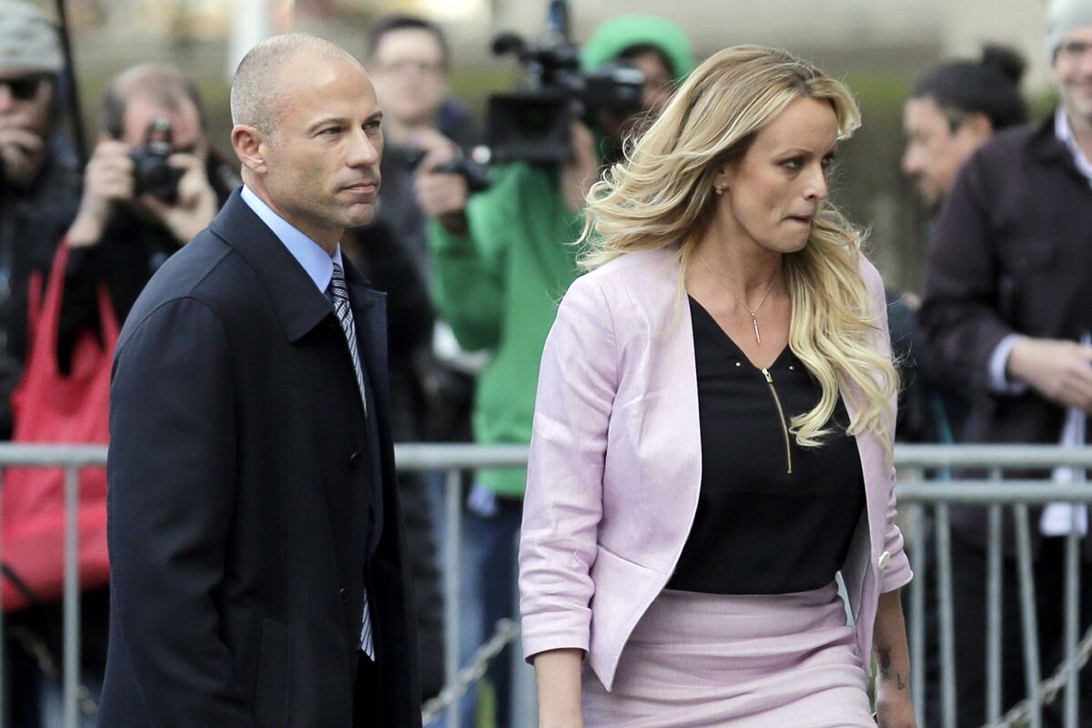 Stormy Daniels and her attorney Michael Avenatti leave federal court in New York.
