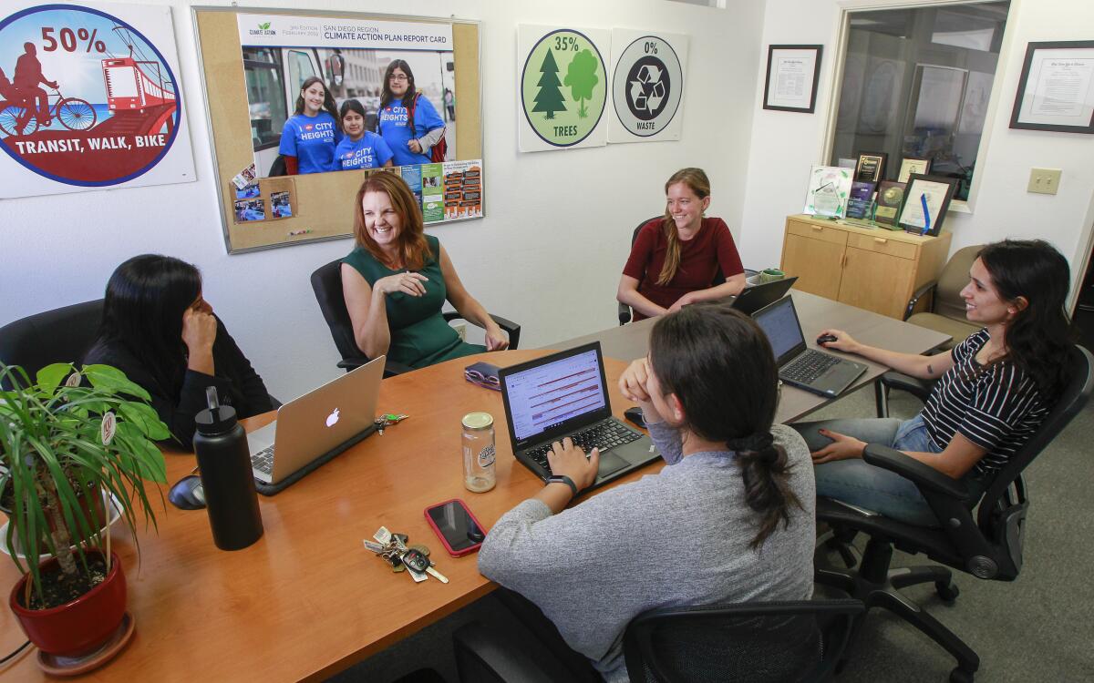 Nicole Capretz (2nd from left), founder and executive director of Climate Action Campaign, works with her team at their University Heights headquarters on October 10, 2019 in San Diego, California. 