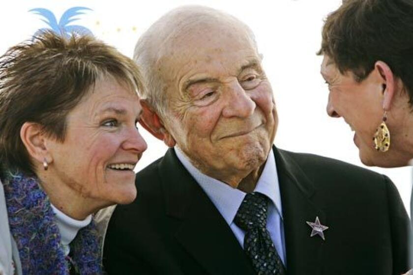 On his 90th birthday in January 2007, Carl Karcher, founder of the Carl's Jr. restaurants, receives a star on the Anaheim/Orange County Walk of Stars. His niece Mary Harrigan is at left. At right is Sue O'Donnell, who worked at one of his original restaurants.