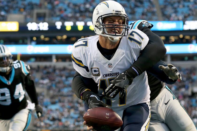 Chargers quarterback Philip Rivers is sacked by Panthers defensive end Mario Addison in the end zone for a safety during second half Sunday.