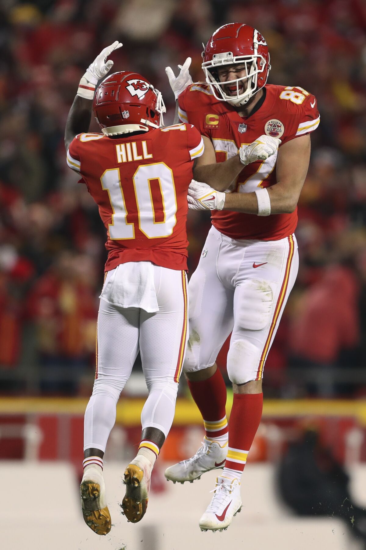 Kansas City Chiefs tight end Travis Kelce (87) celebrates with teammate Tyreek Hill (10) during the second half of an NFL wild-card playoff football game against the Pittsburgh Steelers, Sunday, Jan. 16, 2022, in Kansas City, Mo. (AP Photo/Travis Heying)
