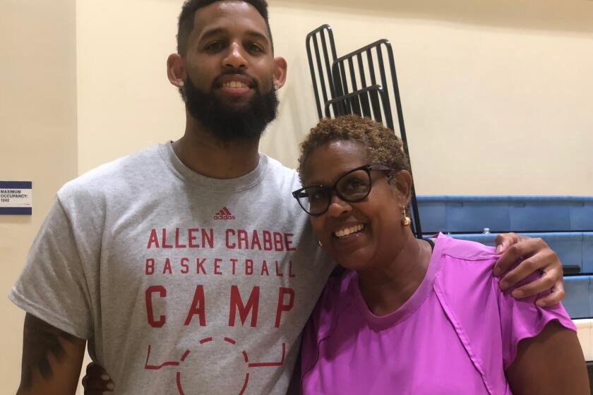 Allen Crabbe of the Atlanta Hawks with his mother, Cheryl, while running a camp at his alma mater, Los Angeles Price.