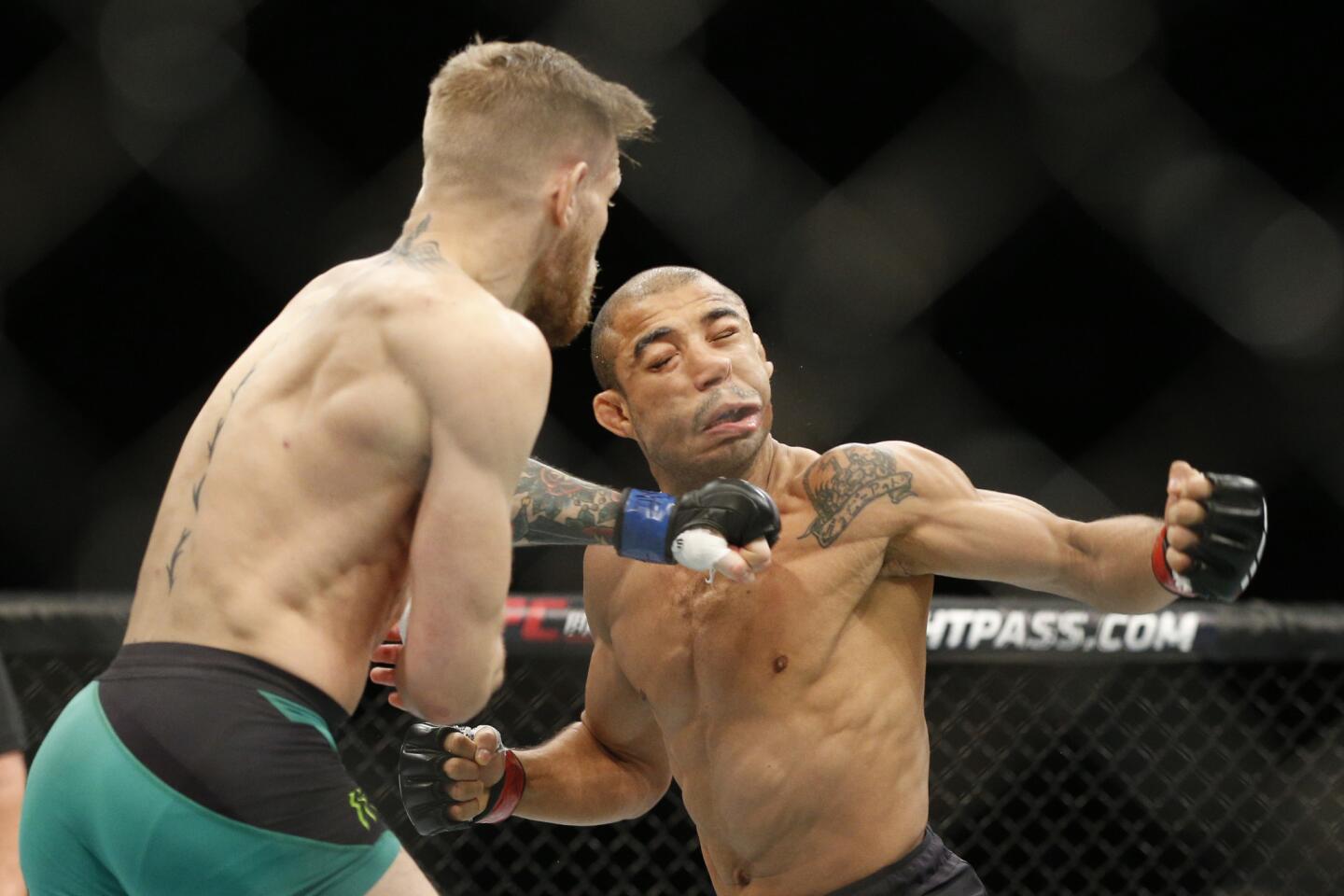 Conor McGregor, left, knocked out Jose Aldo with his first punch at UFC 194 in Las Vegas to claim the featherweight title on Dec. 12.