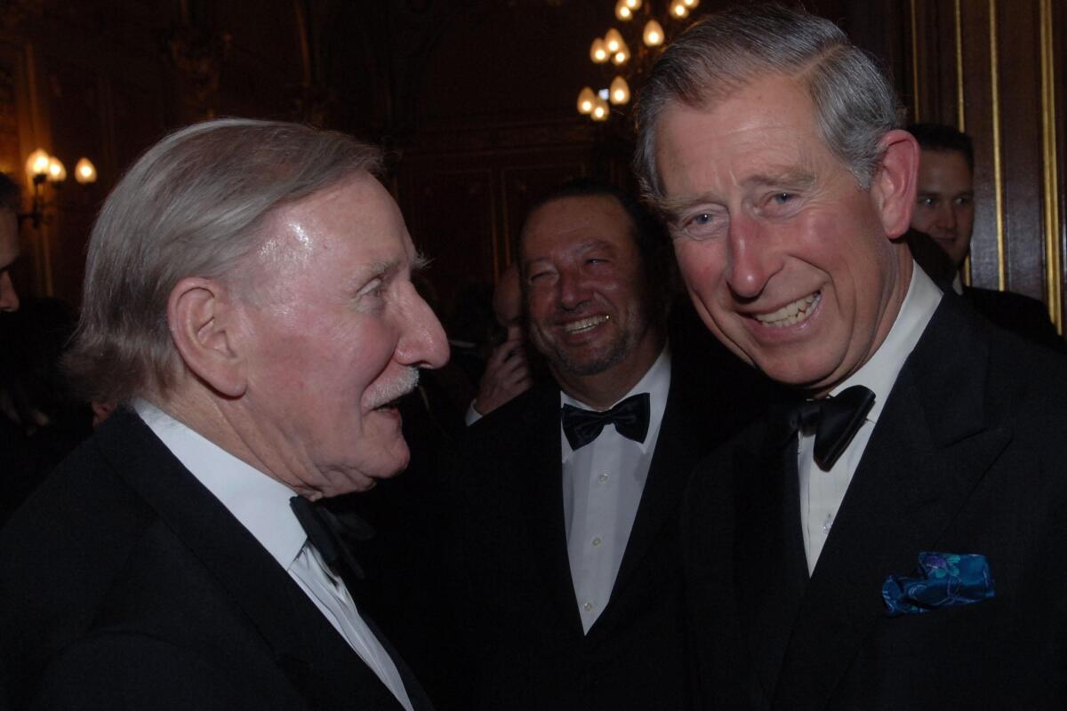 Britain's Prince Charles chats with actor Leslie Philips at the Royal Shakespeare Company's gala fund raising dinner for their 'Complete Works Festival', in London, on May 17, 2006. Leslie Phillips, the British actor best known for his roles in the bawdy “Carry On” comedies and as the voice of the Sorting Hat in the “Harry Potter” movies, has died. He was 98. His agent Jonathan Lloyd confirmed Tuesday that Phillips died “peacefully at home” on Monday. (Stefan Rousseau/Pool Photo via AP)
