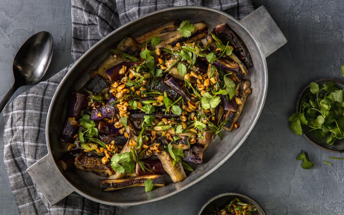 A spicy-sweet topping of peanuts, scallions and ginger adds crunch to a simple dish of lightly charred, stir-fried eggplant. Prop styling by Rebecca Buenik.