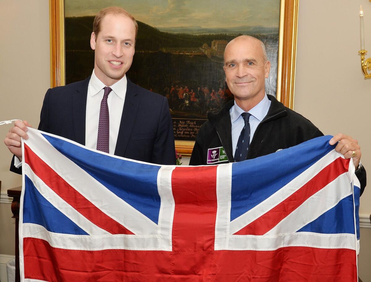 British explorer Henry Worsley, right, with Britain's Prince William as they hold the British flag in London on Oct. 19.