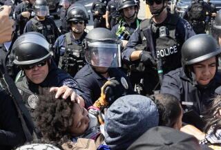 Protesters clash with police in helmets